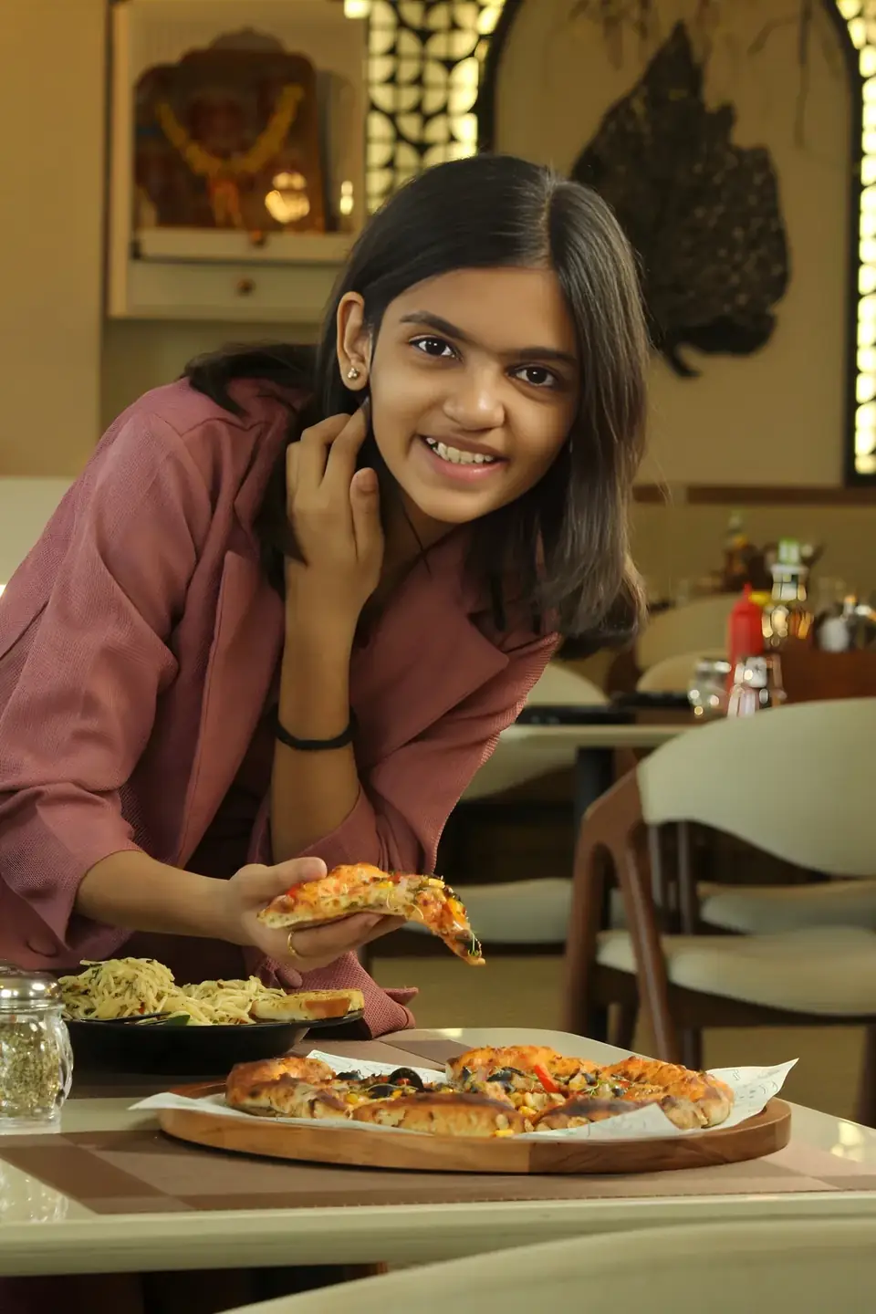 Guest smiling over her pizza